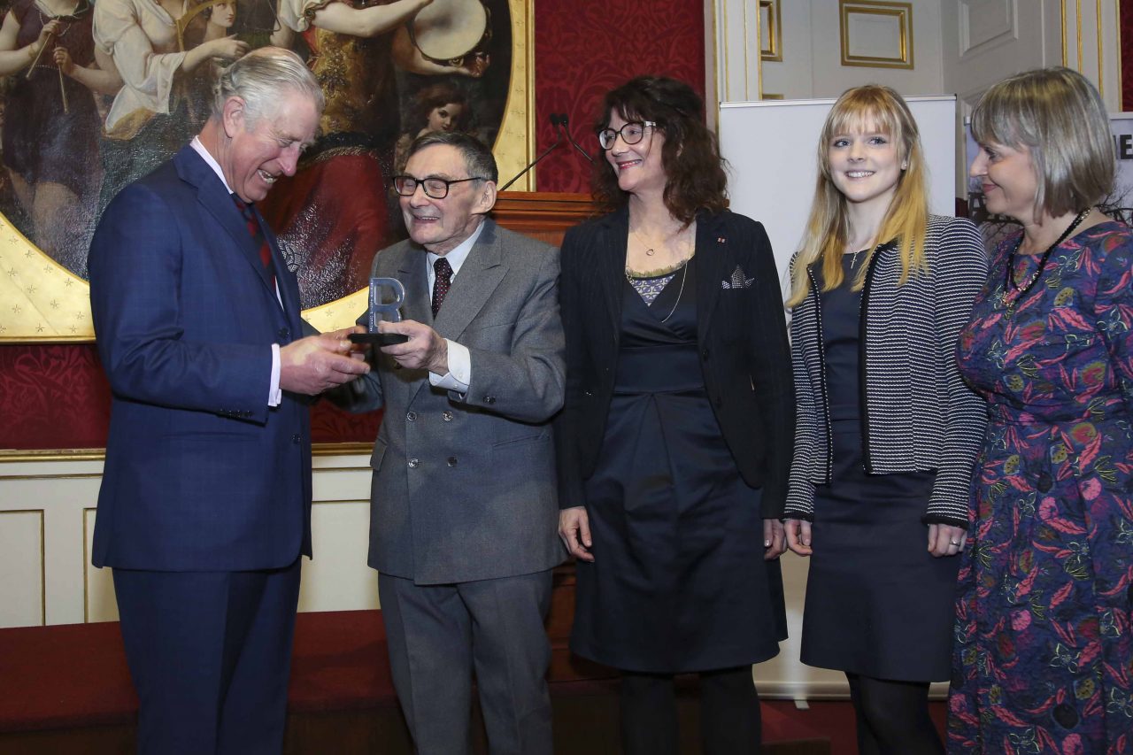 His Royal Highness receives an award from Marian Turski of the International Auschwitz Committee, IAC, Laura Marks OBE