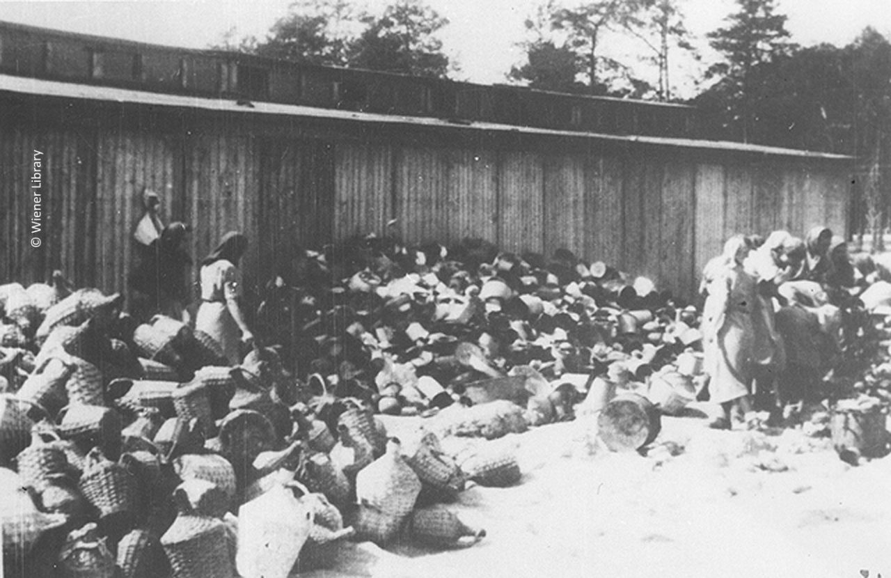 Female inmates sorting belongings of gassed Jews at the Kanada store in June 1944