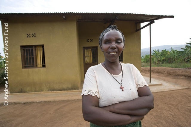 Daphrose - Rwandan survivor outside a school © Andrew Sutton