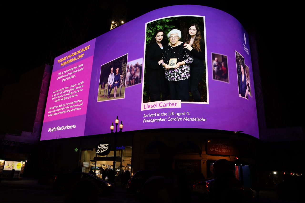 Piccadilly Lights light up with photographs of survivors of the Holocaust