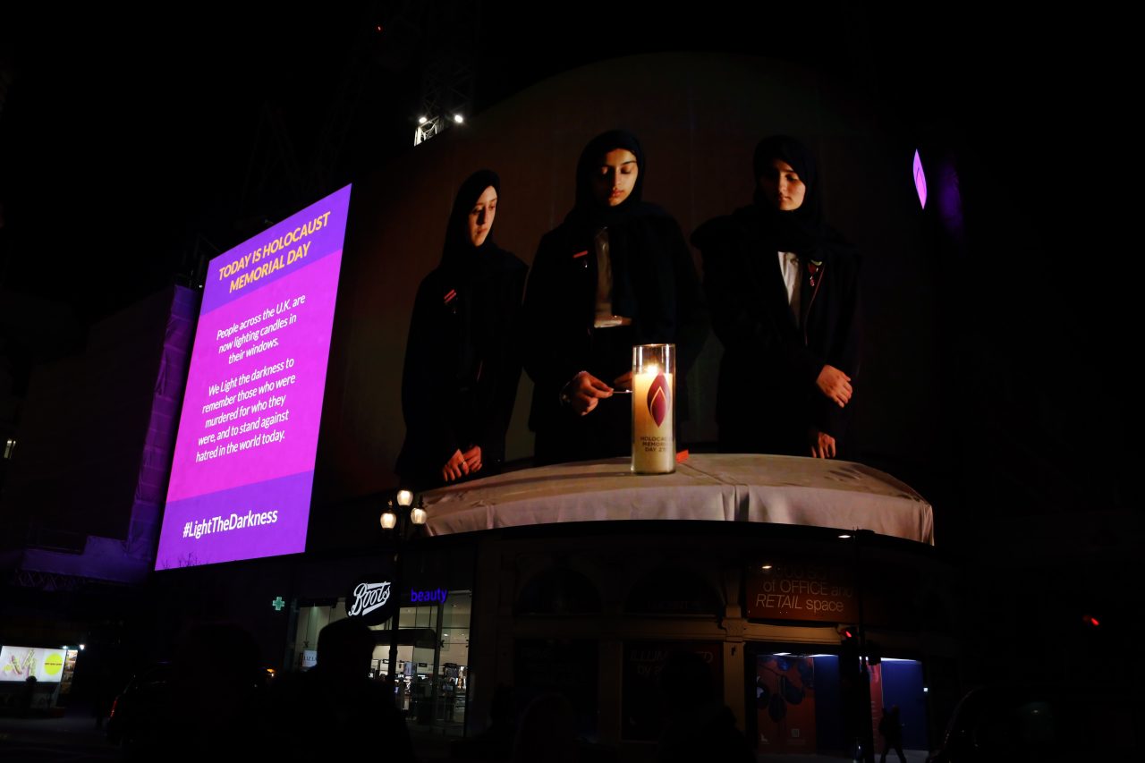 Piccadilly Lights show candle lighting from the UK HMD Ceremony