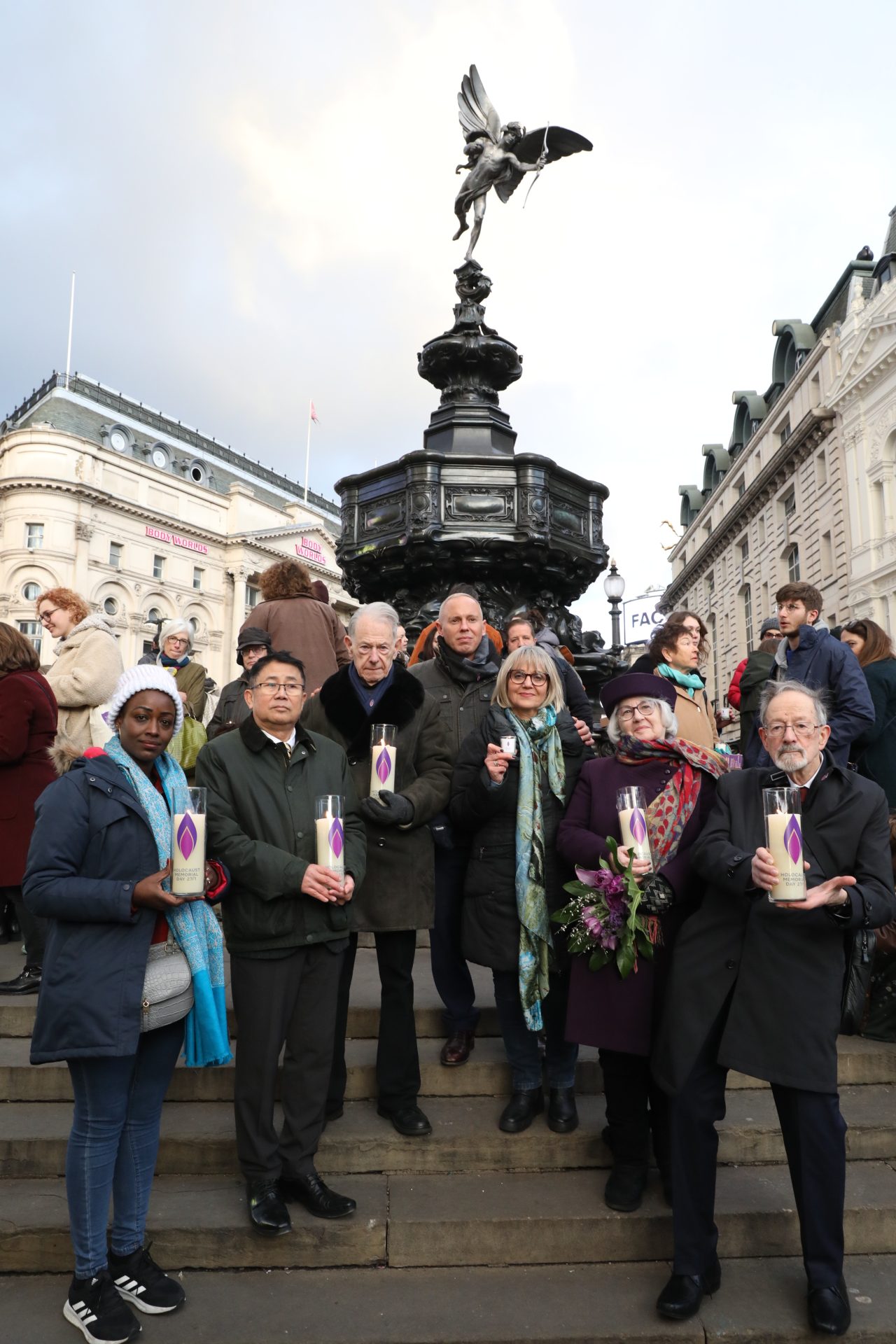 Antoinette Mutabazi, Sokphal Din BEM, John Hajdu MBE, Rob Rinder, Laura Marks OBE, Joan Salter MBE and Dr Martin Stern MBE Light the Darkness together in Piccadilly Circus