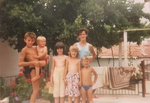 Old photo of Smajo Bešo with five members of his family. All are children, and Smajo is held in the arms of his cousin.